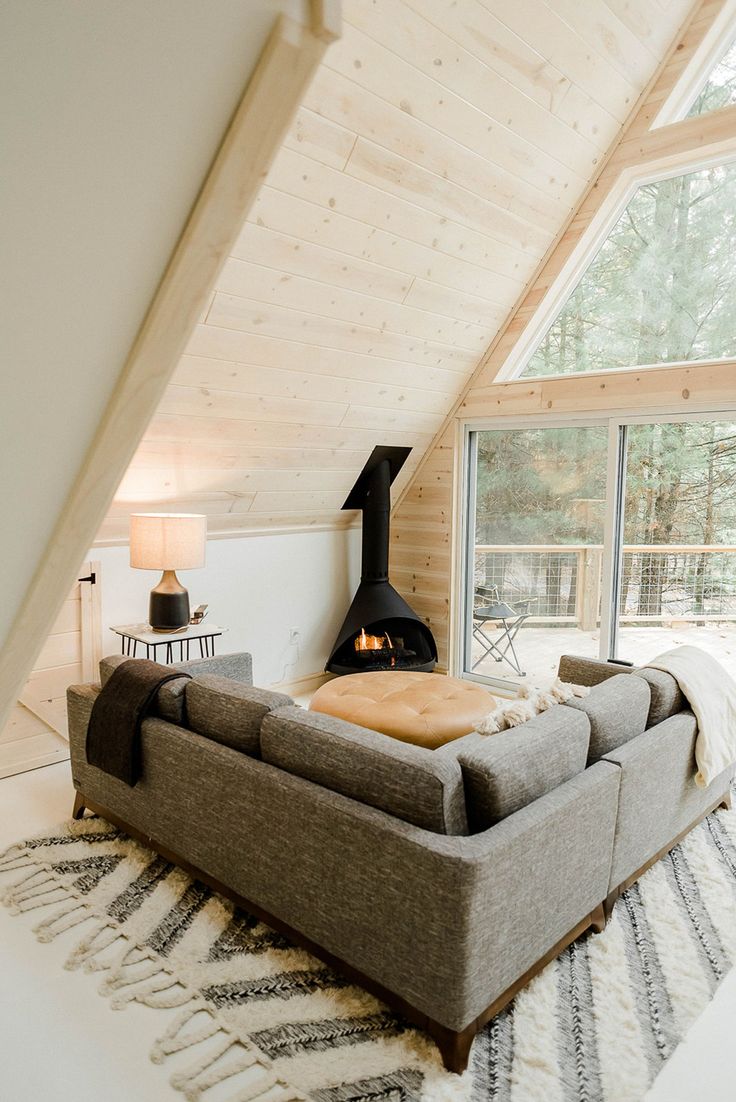 a living room filled with furniture and a fire place in the middle of a room