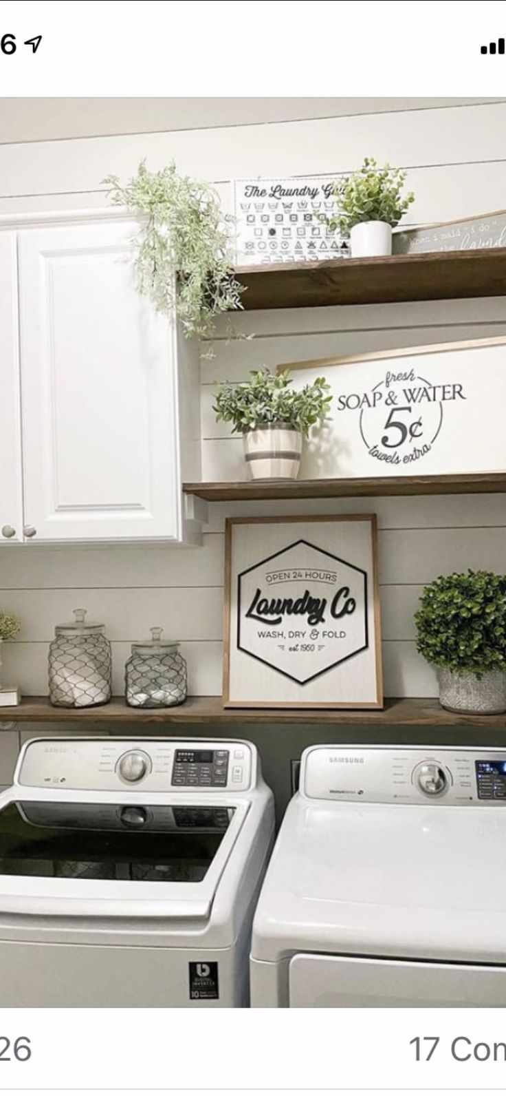 a white washer and dryer sitting next to each other in a laundry room