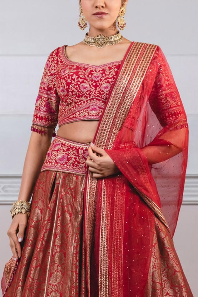 Red brocade lehenga joined with gota and lightly embroidered brocade border. Paired with blouse embroidered with kasab, resham and sequins and sheer silk ombre dupatta with all-over mukaish and gota borders.
Component: 3
Embroidered
Neckline: Scoop
Sleeve Length: Elbow
Fabric: Brocade
Color: Red
Tassel details
Back deep neck blouse with tassel tie-up
 - Aza Fashions Red Sharara For Reception, Anarkali Red Choli With Gota Work, Anarkali Style Red Choli With Gota Work, Red Cutdana Lehenga With Traditional Drape, Red Cutdana Traditional Drape Lehenga, Red Chanderi Dupatta For Reception, Red Bollywood Lehenga With Cutdana, Red Choli With Cutdana For Navratri, Red Gota Work Choli For Reception