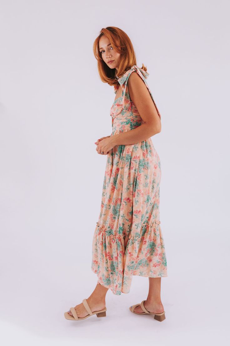 Get ready to escape into style with The Great Escape Dress! This playful maxi dress features a salmon hue with a unique pink, green, and white pattern for an eye-catching look. The tiered skirt adds extra movement and the smocked back and ruched bodice ensure a perfect fit. Make a statement with this fun and flirty dress! Details Maxi length Salmon dress with pink, green, and white pattern Tier on skirt Smocking on back Ruching down bodice Adjustable tie sleeves Knee length lining Back zipper Si Nursing Friendly Tops, Salmon Dress, Nursing Friendly Dress, Plus Jumpsuit, Great Escape, The Great Escape, Exclusive Dress, Flirty Dresses, Ruched Bodice