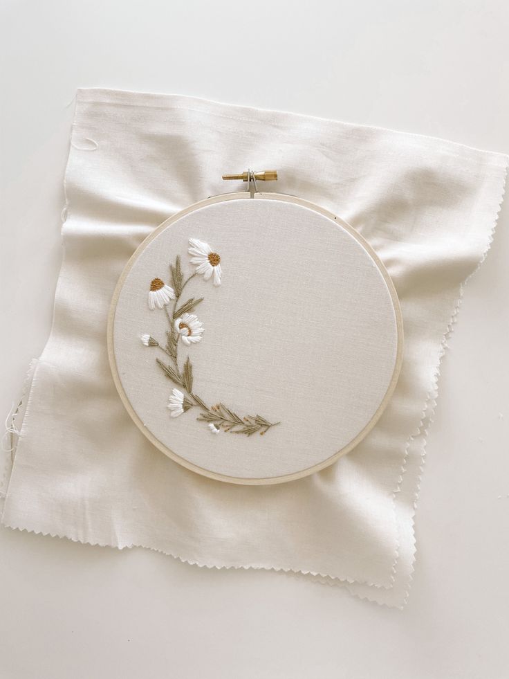 a white cloth with embroidered flowers on it