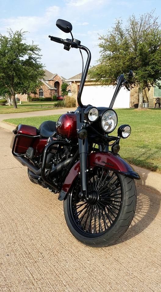 a red motorcycle parked on the side of a road