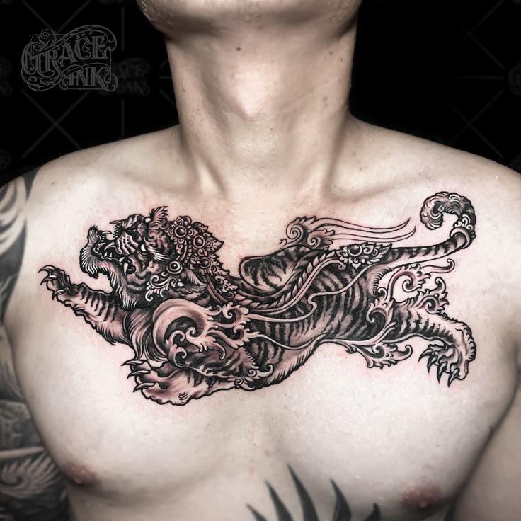 a man with a dragon tattoo on his chest