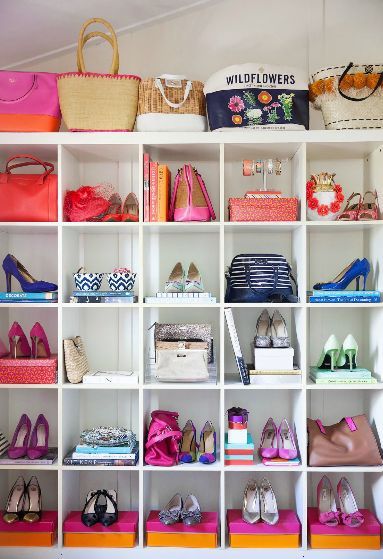 a white shelf filled with lots of purses and shoes