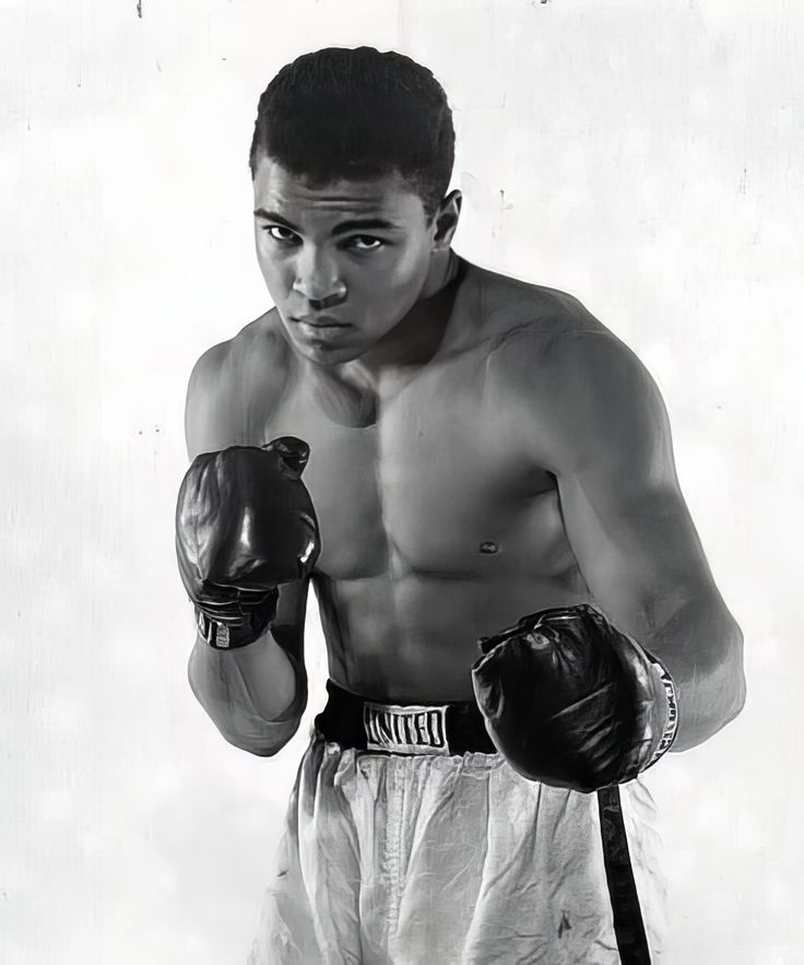 an old black and white photo of a man wearing boxing gloves