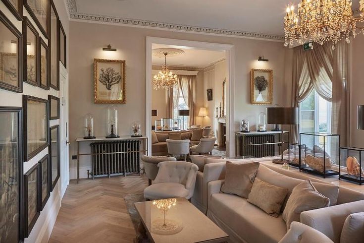 a living room filled with furniture and a chandelier