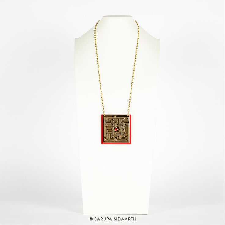 Gold and Red Acrylic Maze Necklace. Acrylic, antique gold finish stainless steel chain.Pendant height: 3 in. / 7.5 cms.Pendant width: 3 in. / 7.5 cms.Necklace length: 15.5 in. / 40 cms. NOTE:Each handmade accessory may have slight irregularities or imperfections, which add to its charm, while ensuring that you have a unique piece. All jewelry measurements are approximate. COLOR:Every effort is made to display the colors of each accessory as accurately as possible. However, each monitor reproduce Modern Chain Necklace With Detachable Pendant For Gifts, Chain Necklace With Detachable Pendant As A Gift, Gift Detachable Pendant Chain Necklace, Antique Gold Brass Medallion Necklace As Gift, Red Metal Chain Necklace As Gift, Gold Copper Chain Necklace As Gift, Red Long Necklace For Gift, Antique Gold Brass Medallion Necklace Gift, Antique Gold Brass Medallion Necklace For Gift