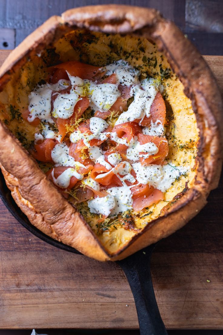 a pizza sitting on top of a wooden cutting board covered in cheese and toppings