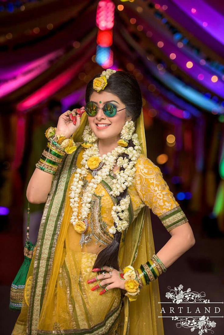 a woman dressed in yellow and green poses for the camera