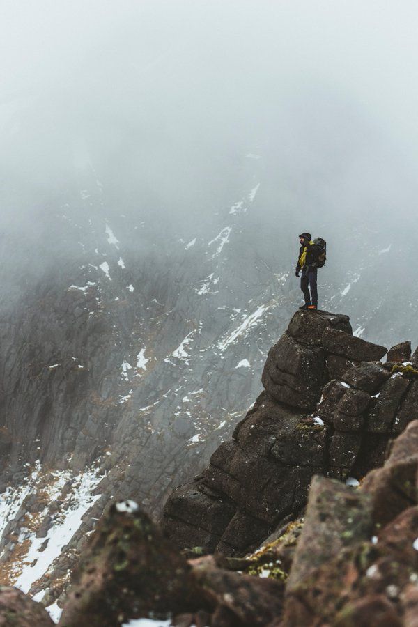 a man standing on top of a rocky mountain