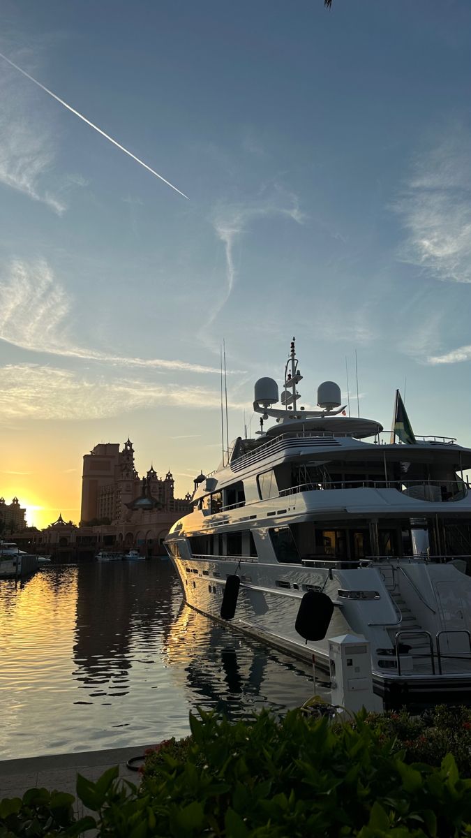 a large white boat in the water at sunset