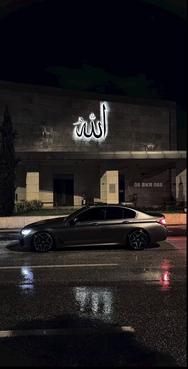 a car parked in front of a building with arabic writing on it's side