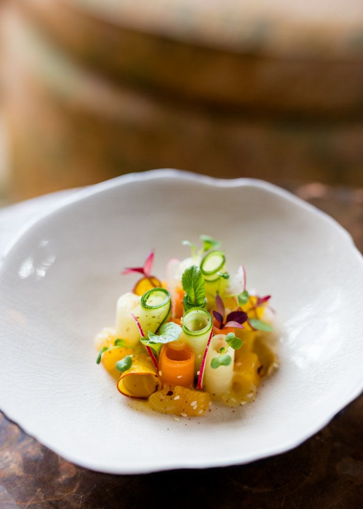 a white bowl filled with food on top of a wooden table