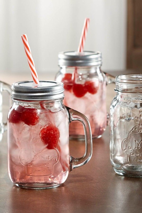 three mason jars filled with ice and cherries