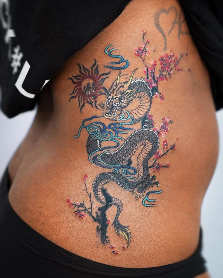 a woman with a dragon tattoo on her stomach