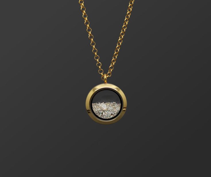 "This unisex customizable cremation ash locket is new to our collection of fill-at-home cremation pieces. Your purchase includes the gold toned locket, gold toned chain, and opal color of your choice and does not require mailing the ashes. It is composed of sturdy glass and gold-toned stainless steel (hypoallergenic, scratch/tarnish resistant). The chain is 32\". If screwed properly, the locket is air and watertight. The round pendant measures 25mm across and is the perfect size for a classy and Necklace For Ashes, Diy Urns For Ashes, Ashes Necklace Cremation Jewelry, Gold Cremation Necklace, Necklace Ashes, Thumbprint Jewelry, Memorial Brass Pendant Necklace, Urn Necklaces For Ashes, Ash Pendant Cremation Jewelry