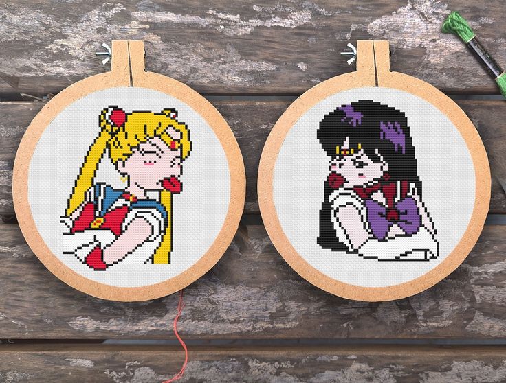 two cross - stitch hoops with cartoon characters on them