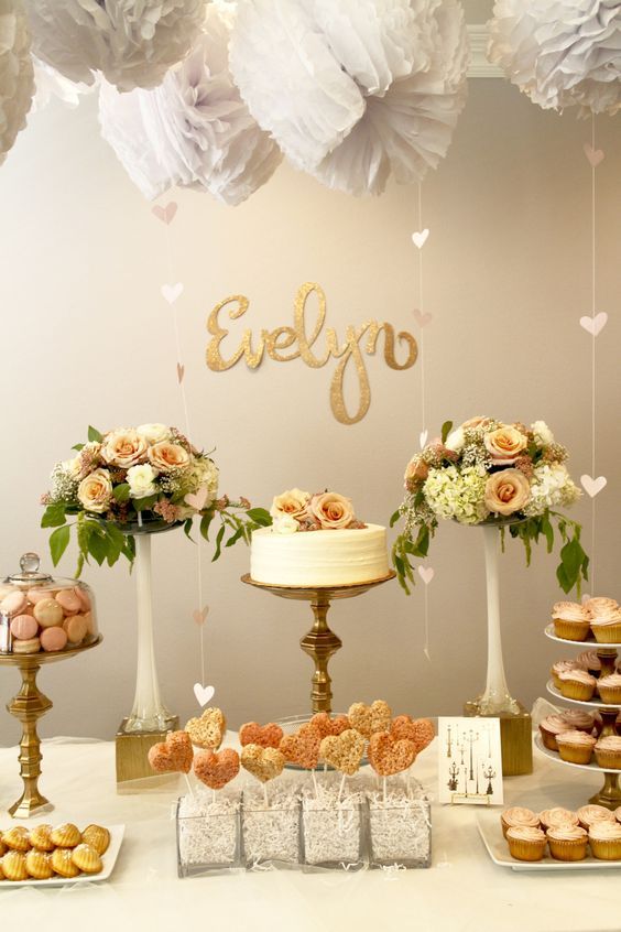 a dessert table with cupcakes and cakes on it