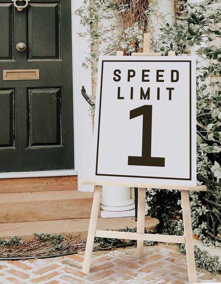 a speed limit sign sitting in front of a door