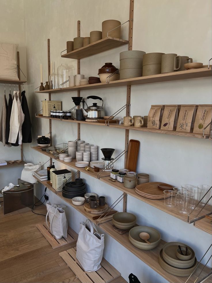 the shelves are filled with pottery and other items