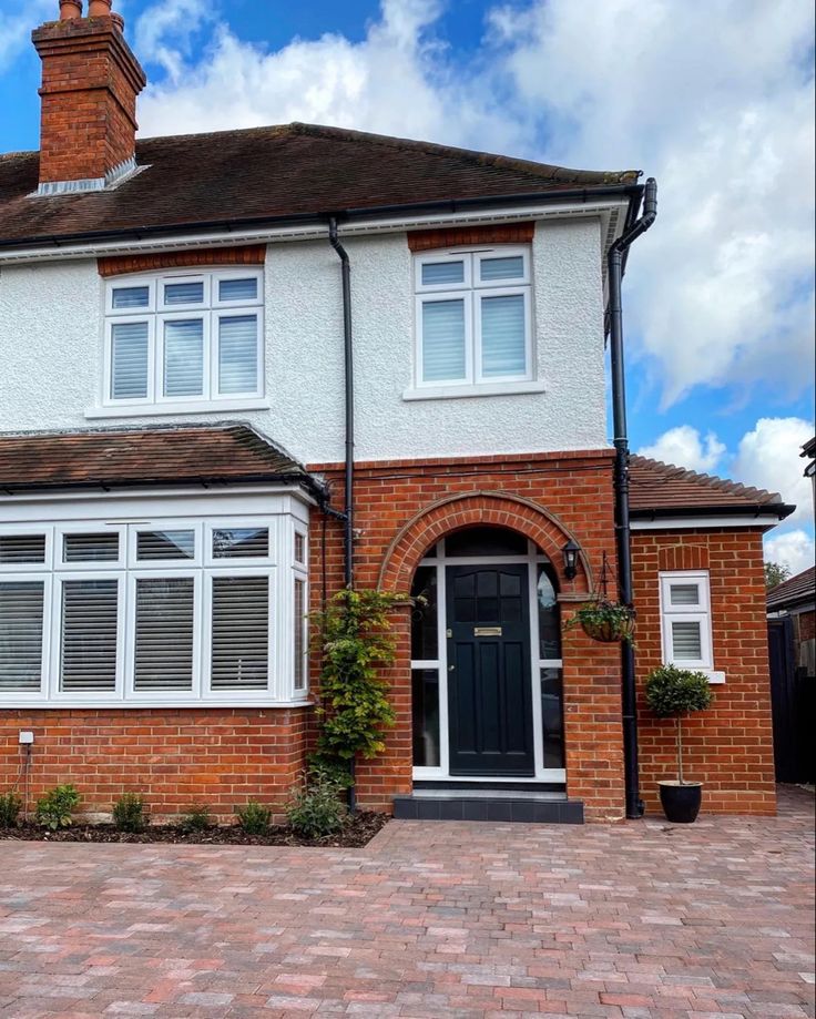 a large brick house with white trim and windows