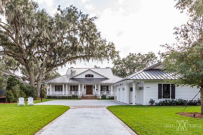 a white house with trees in the front yard