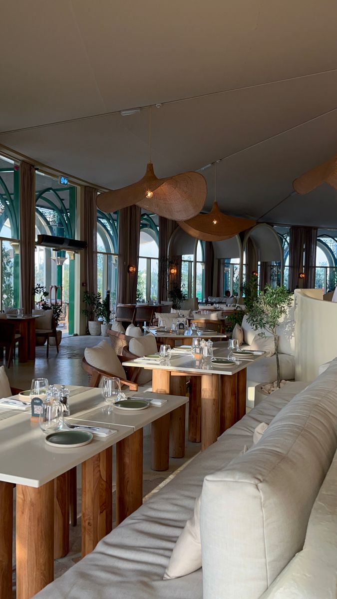 an empty restaurant with tables and couches