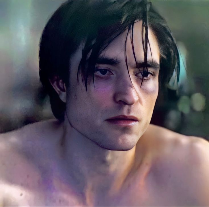 a shirtless man with black hair and no shirt on is looking at the camera