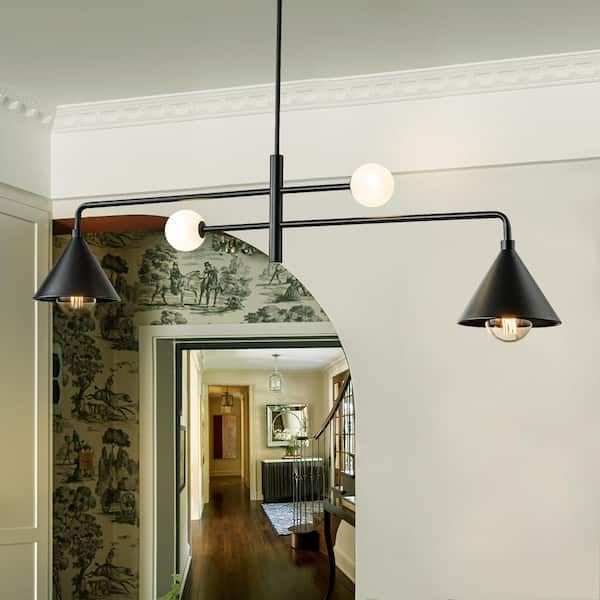 a hallway with a mirror and two lights hanging from it's ceiling above a wooden floor