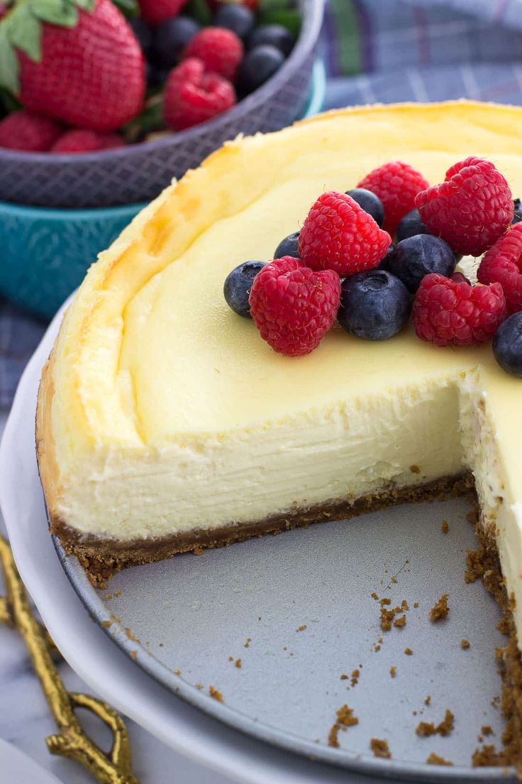 a cheesecake with berries and blueberries on top