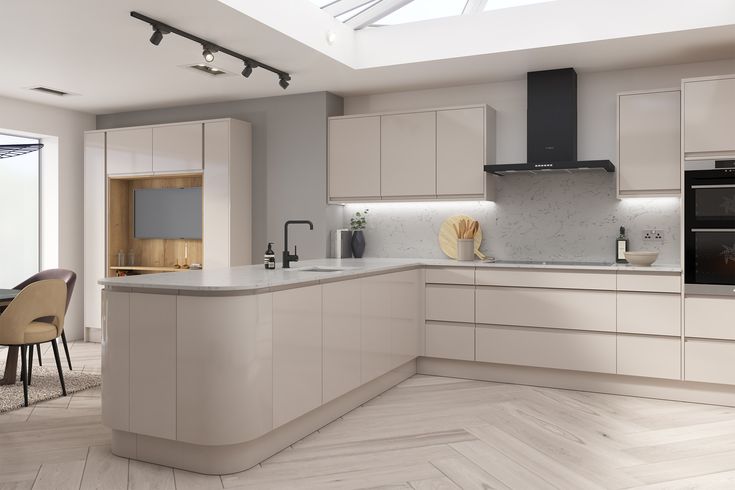 a modern kitchen with white cabinets and wood flooring