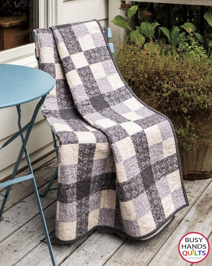 a black and white quilt sitting on top of a chair