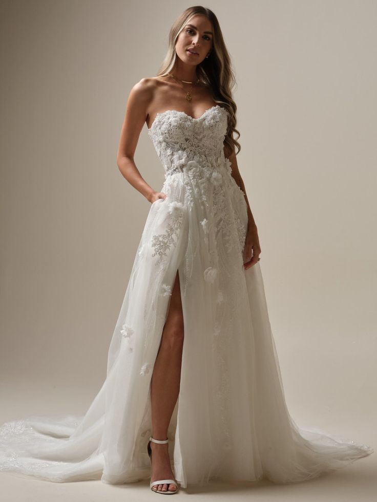 a woman in a white wedding dress posing for the camera