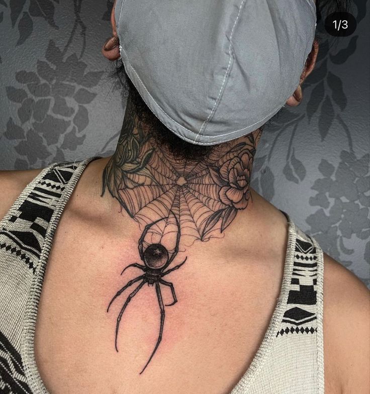 a woman with a spider tattoo on her neck and back, wearing a baseball cap