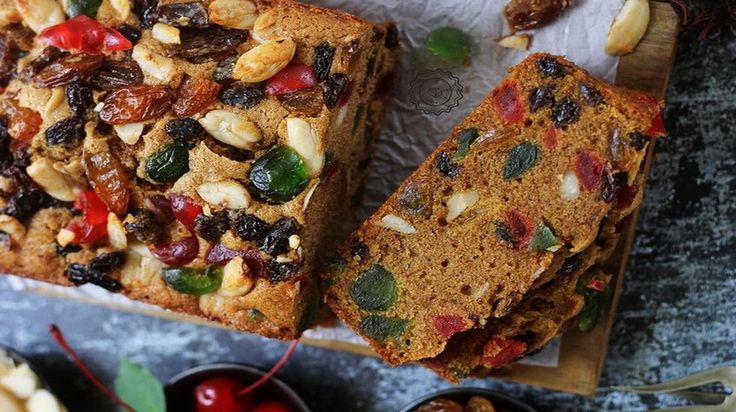 two slices of fruit bread sitting on top of a cutting board