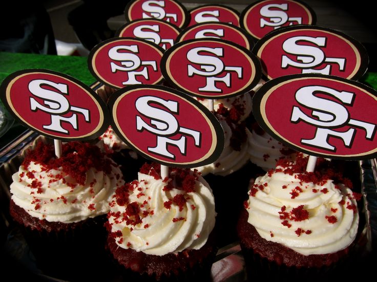 cupcakes with white frosting and red sprinkles on top