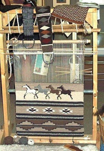 a weaving machine with two horses on it