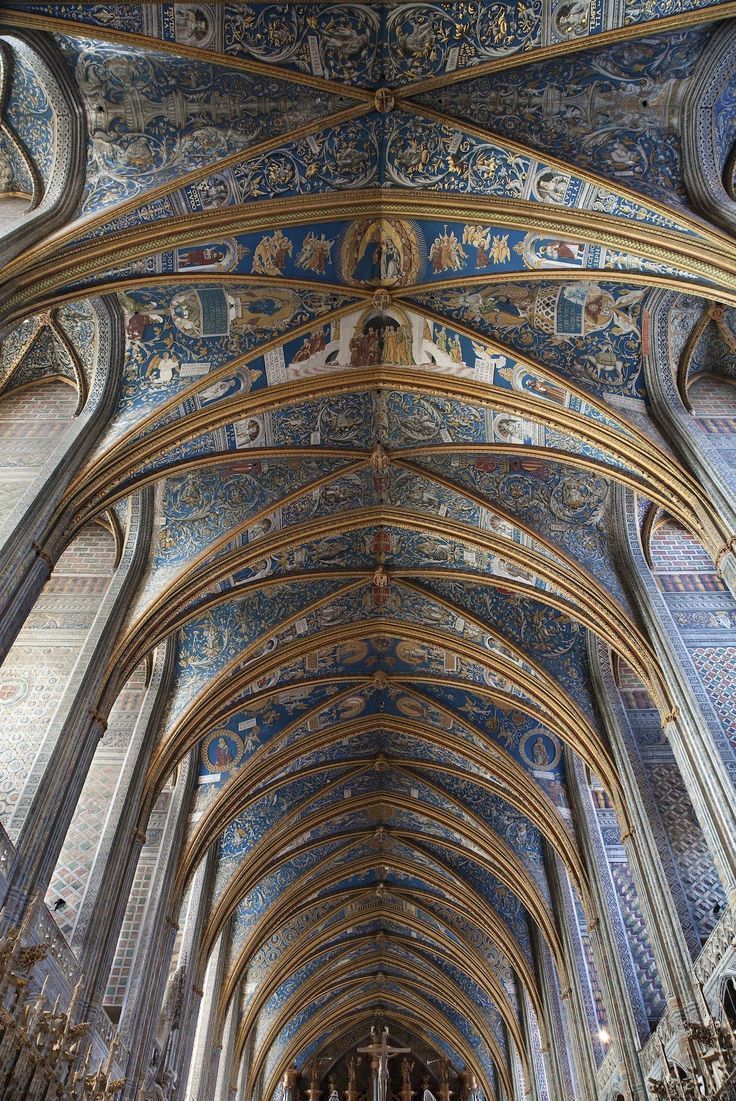 an ornate cathedral with blue and gold paint on the ceiling is pictured in this image