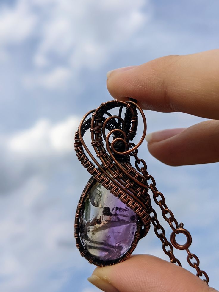 This necklace is an Ametrine cabochon wrapped in copper weaves, and aged. I've been having so much fun making these weaves and learning more with each necklace. I try to show my passion in each of my necklaces and this one is no exception. The stone is so clear and has beautiful colors, which are complimented by the copper wire. Over all a gorgeous and unique necklace. Like all my pieces, this necklace is a one of a kind piece, and once it's gone, it's gone. Wire Wrap Necklace, Wrap Necklace, Wire Wrapped Necklace, Unique Necklace, My Passion, Unique Necklaces, Wire Wrap, Copper Wire, Pendant Necklaces