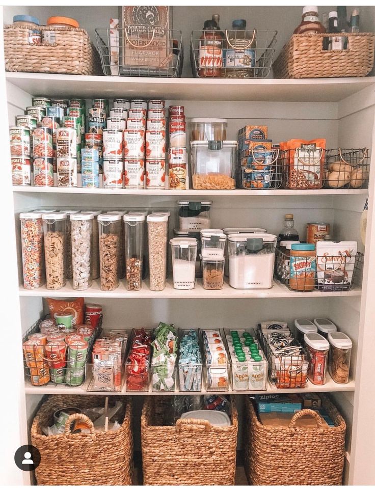 a pantry filled with lots of food and storage baskets on top of white shelving