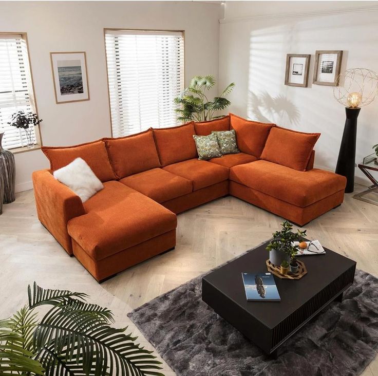 an orange sectional couch in a living room