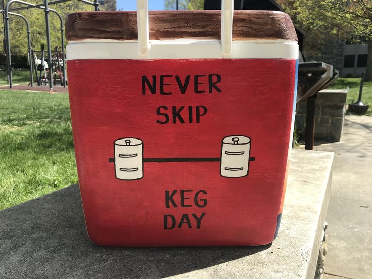 a red cooler bag sitting on top of a cement slab