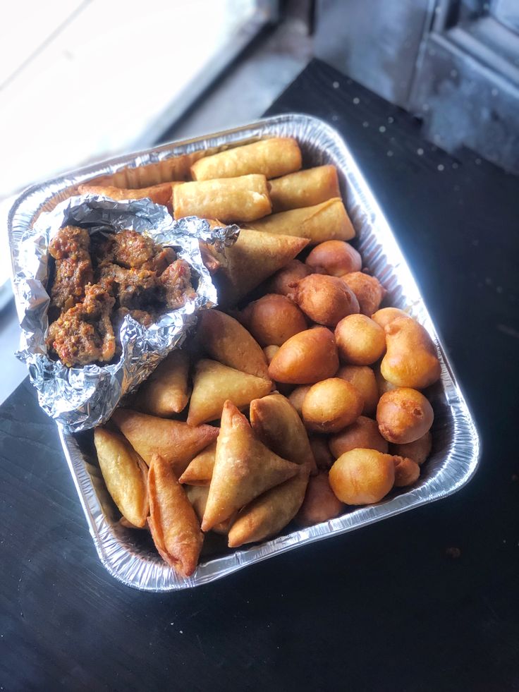 some food is in a metal container on a table