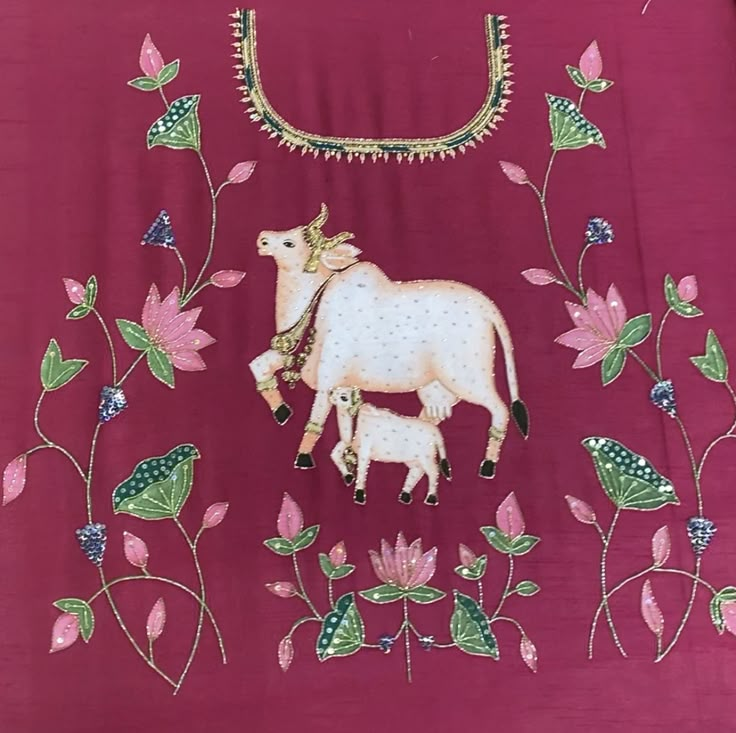 an embroidered cow and calf on a pink background