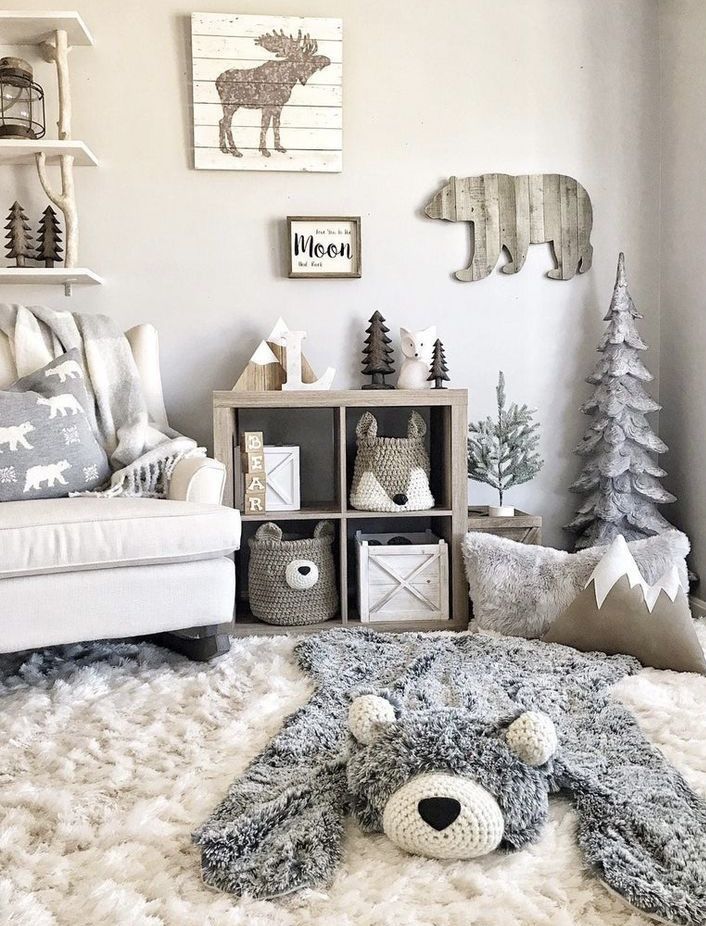 a living room filled with furniture and christmas decorations on the walls, along with a teddy bear rug