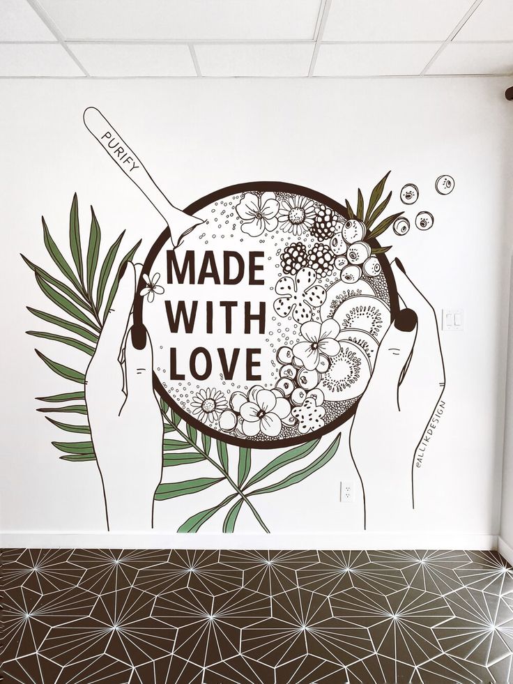 a white wall with an advertisement on it that says made with love and two hands holding a bowl of food