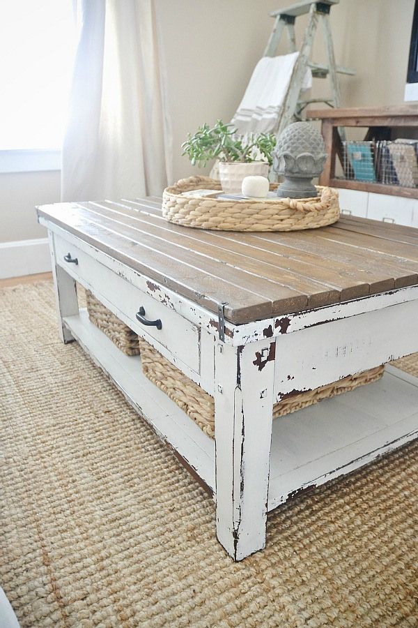 a white coffee table with wicker baskets on top