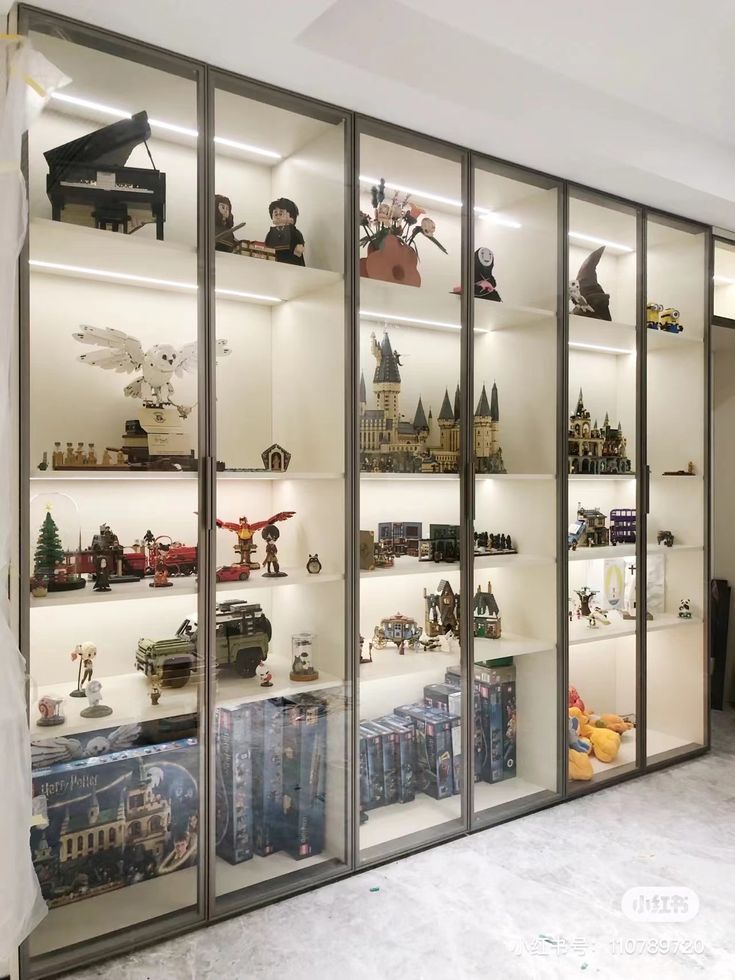 a display case filled with lots of toy figurines and toys in it's glass doors