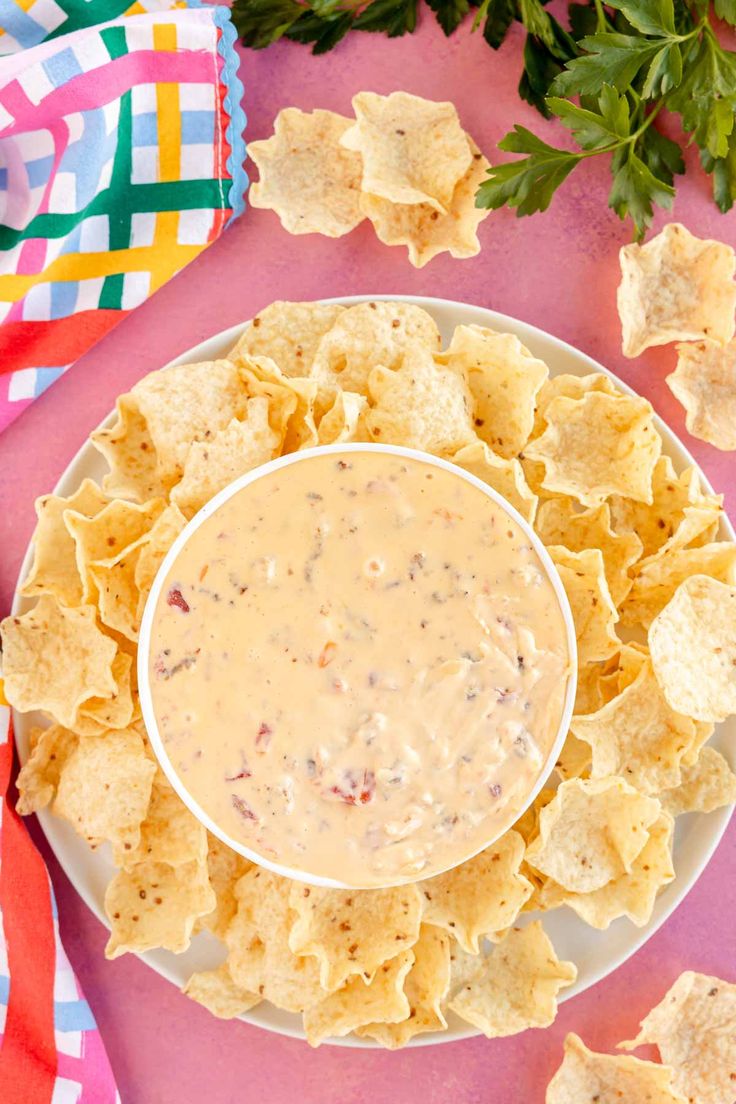 a white plate topped with tortilla chips and salsa