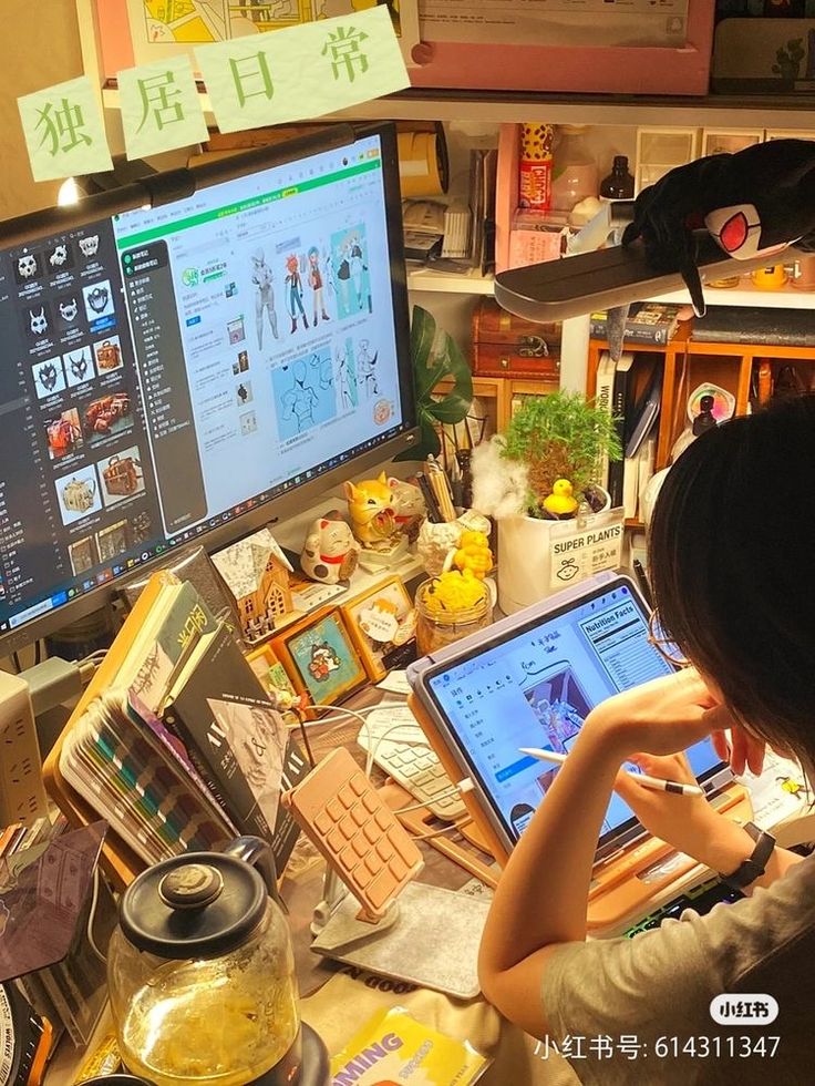 a woman sitting in front of a computer on top of a desk